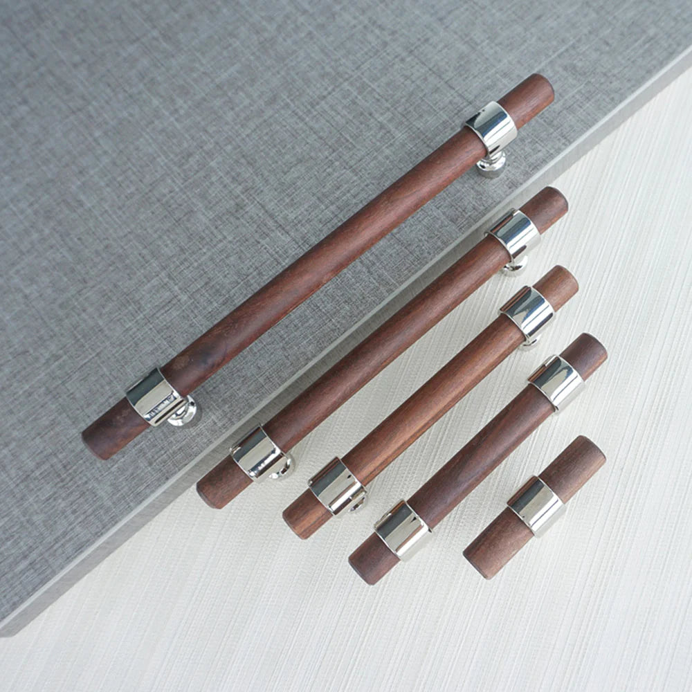 Set of walnut drawer handles in different lengths on gray background.