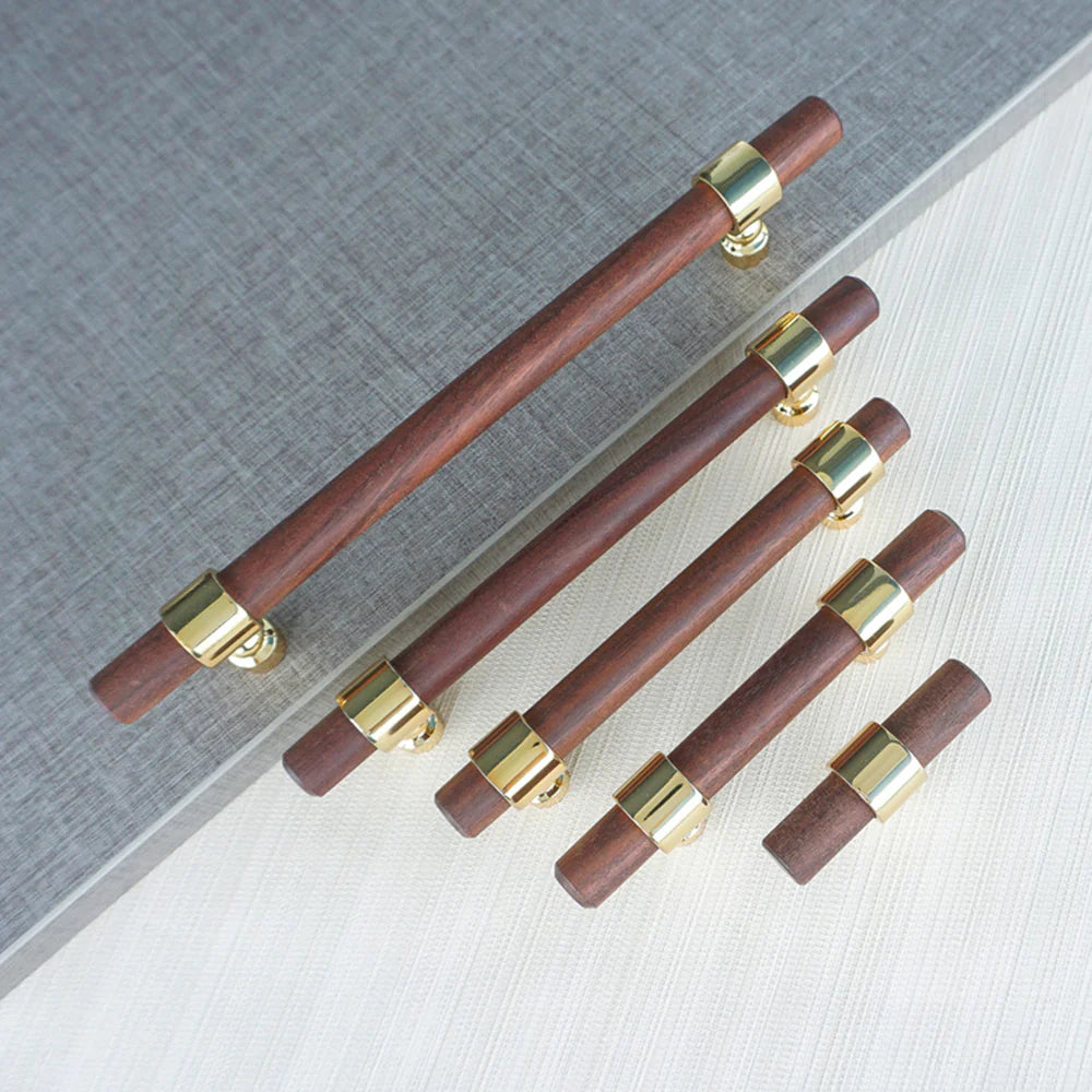 Set of walnut drawer handles in different lengths on gray background.