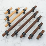 Set of wood and walnut  drawer handles with black brackets.