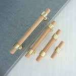 Modern wood drawer handles with gold mounts.