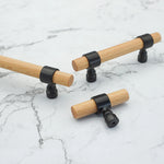 Assorted wood drawer handles in various sizes with black brackets.