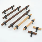Assorted walnut wood drawer handles in various sizes with black brackets.