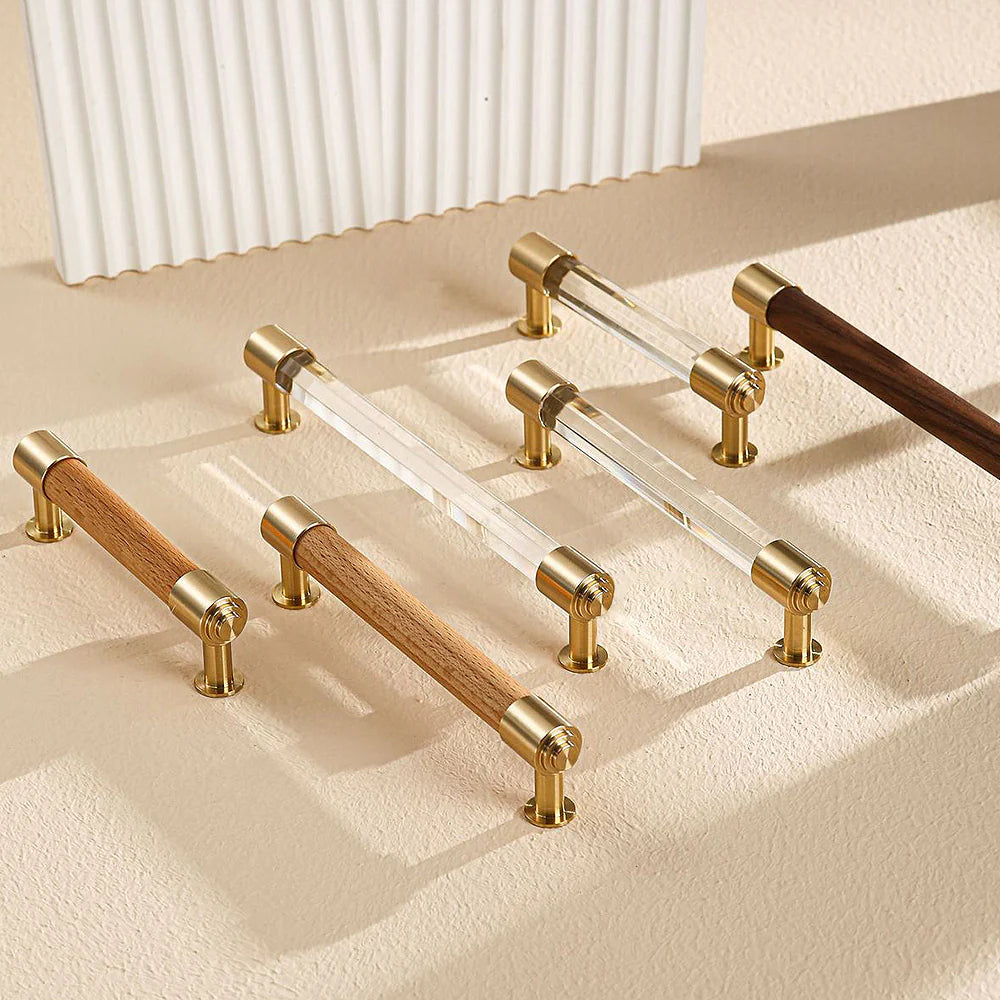 Set of brass and crystal cabinet handles in mixed wood and clear crystal finishes.