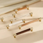 Brass and crystal cabinet handles displayed in walnut and beech styles.