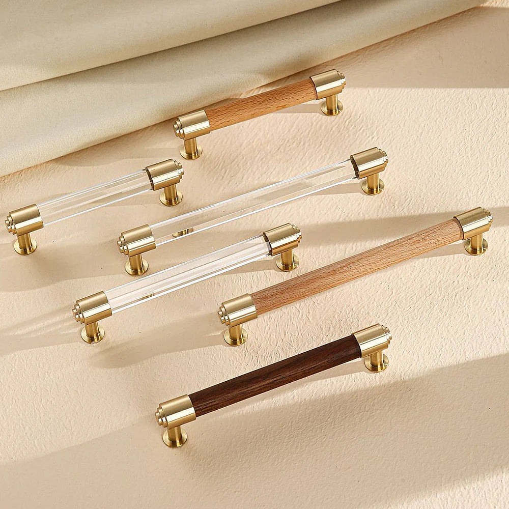 Brass and crystal cabinet handles displayed in walnut and beech styles.