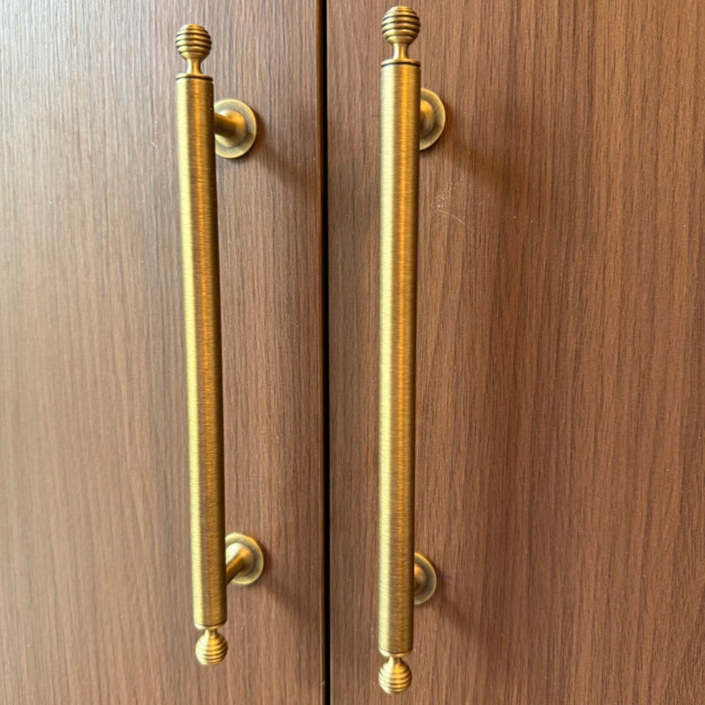 Pair of wooden doors with gold handles on a wooden background
