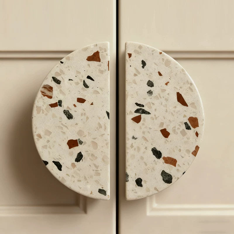 Round terrazzo-style cabinet knobs on a neutral background