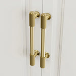 Textured brass cabinet pull handle with vintage finish on the white door
