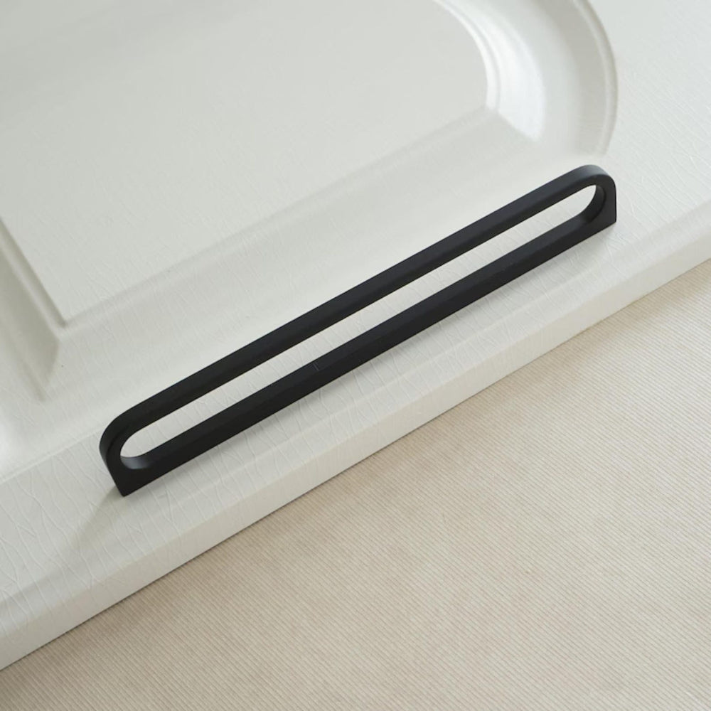 Black towel bar on a white bathtub and beige floor