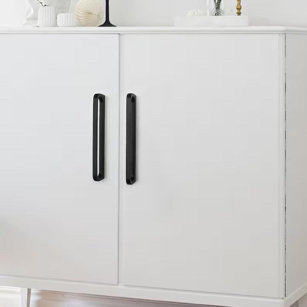 White cabinet with black handles on a white background