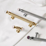 Decorative handles in gold, silver, and purple on a white background